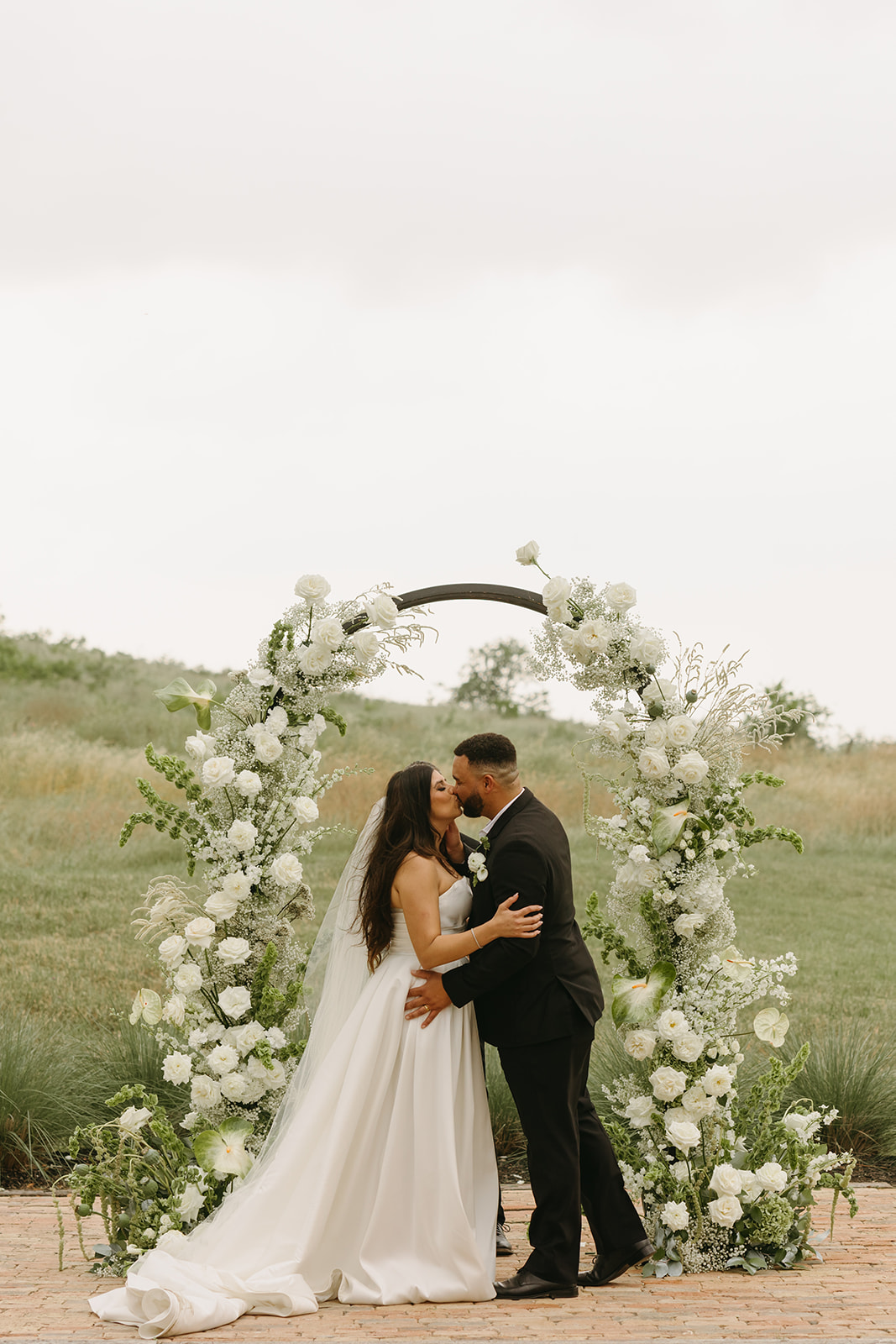 Austin couple with funky wedding florals ceremony arch at Two Wishes Ranch.